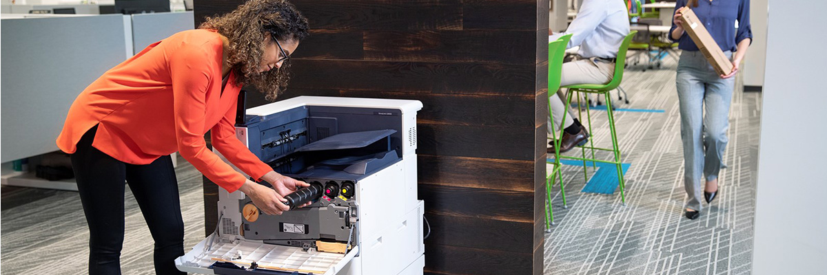 Woman changing Xerox printer toner