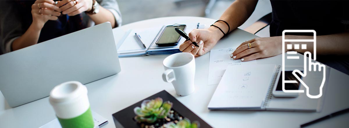 Meeting table with laptop, coffee, smartphones, and notebooks, overlaid with an icon of a hand touching a smartphone