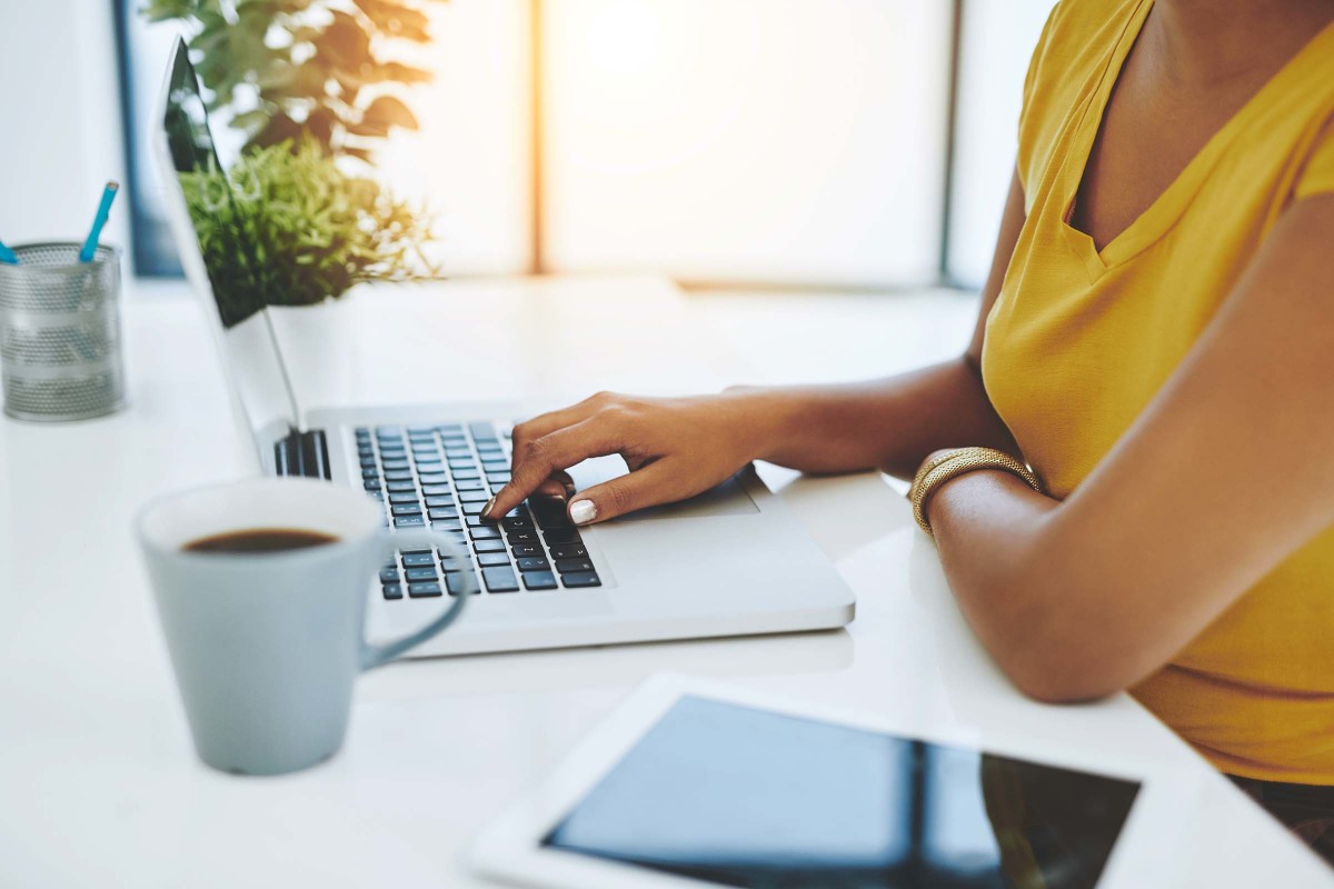 woman yellow shirt laptop coffee