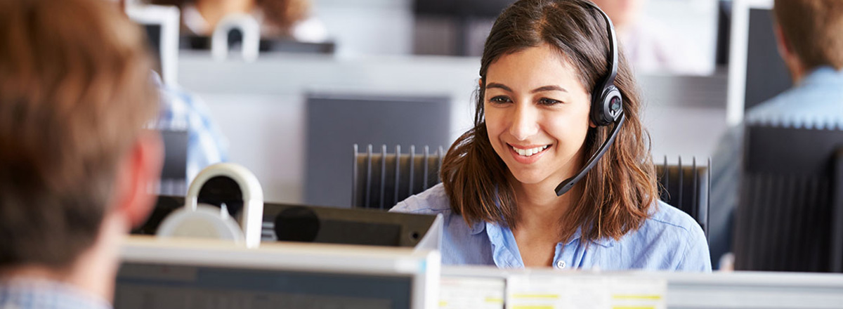 Smiling customer service rep in a call center