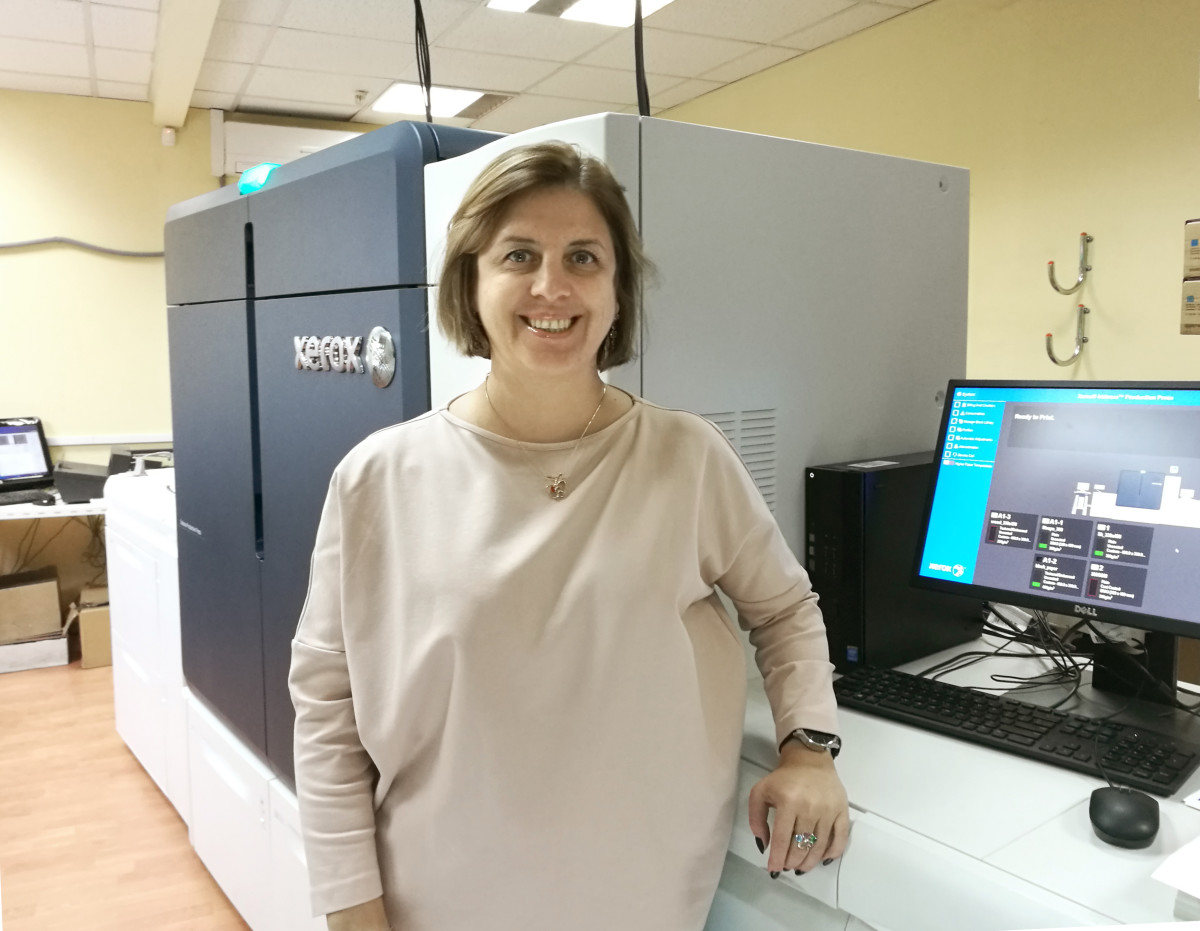 woman standing nect to printer