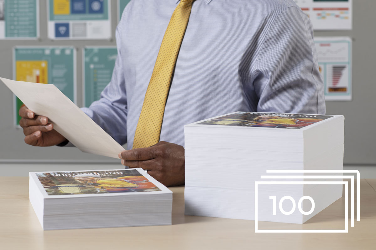 Man reviewing large stack of printouts