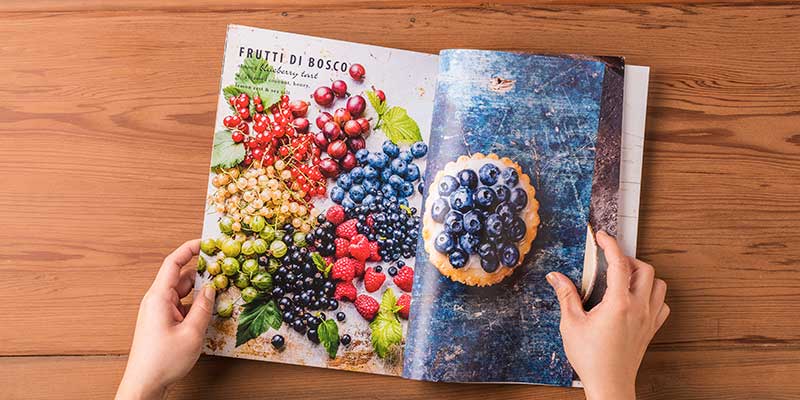 Magazine pages with pictures of many colors of berries, printed on a Xerox Versant Press