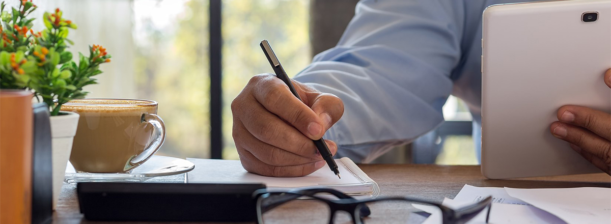 man writing tablet glasses