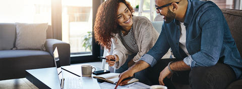 Woman talking to man at coffee table