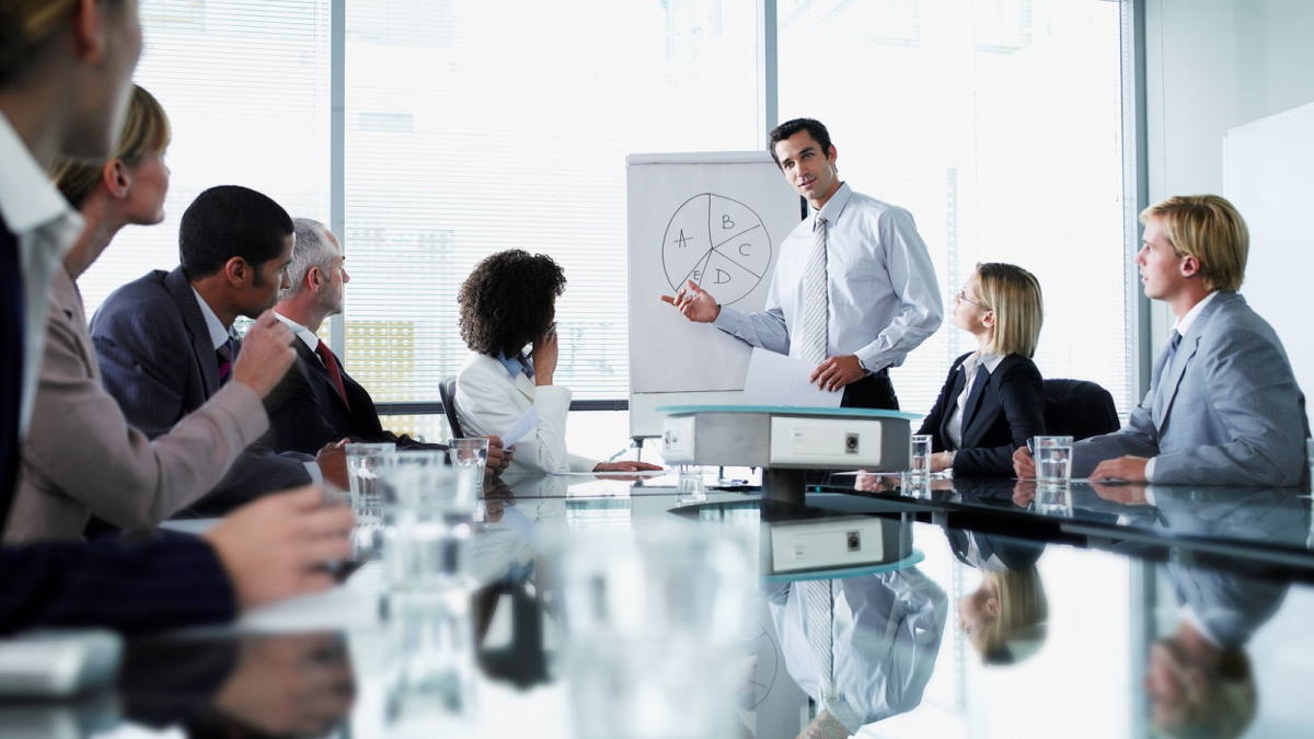 Man presenting at flipchart in meeting room