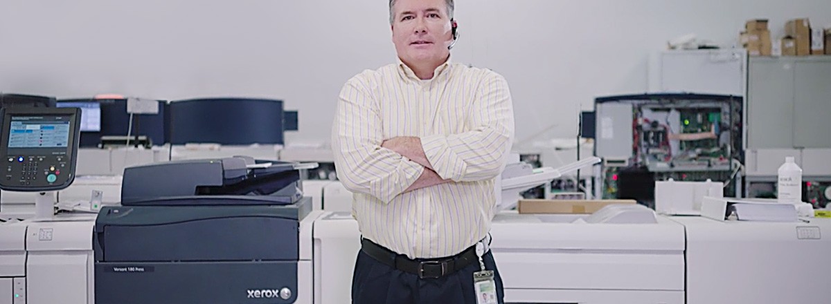 Man standing in front of a collection of Xerox digital presses