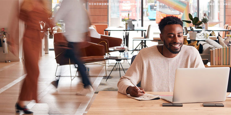 black man working on a laptop in an office