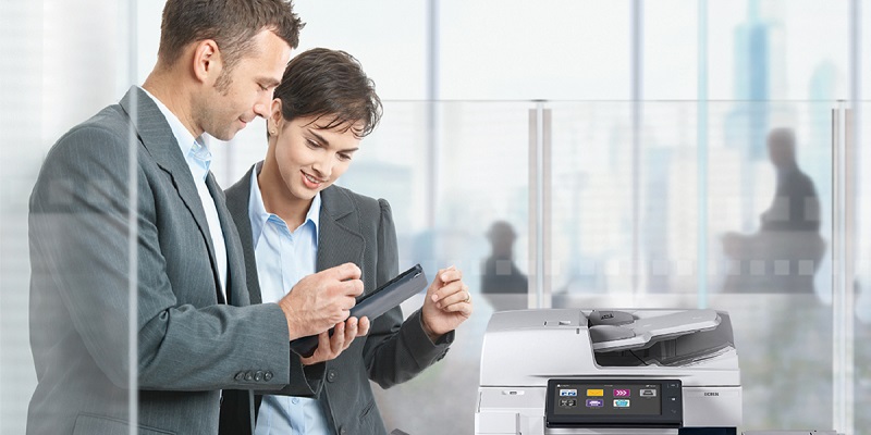 two people around a printer