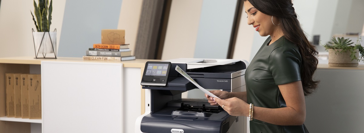 Woman standing in front of printer