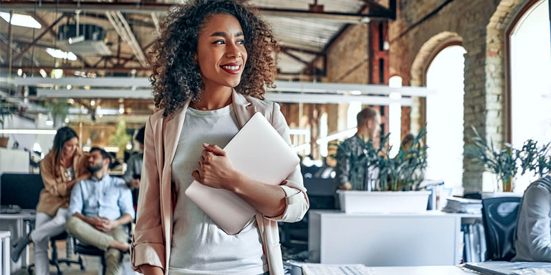 woman holding tablet in modern office setting