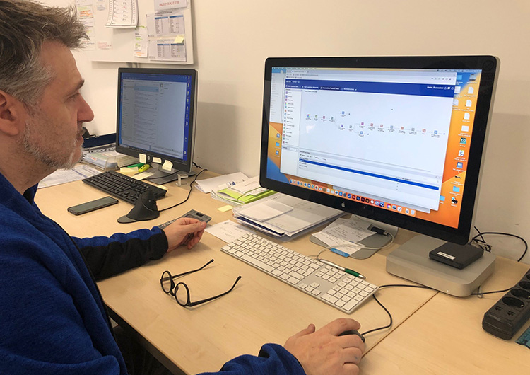 Man sitting at computer looking at the screen