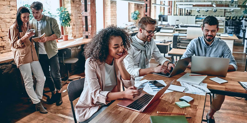 young diverse employees working in modern office technology mobile device