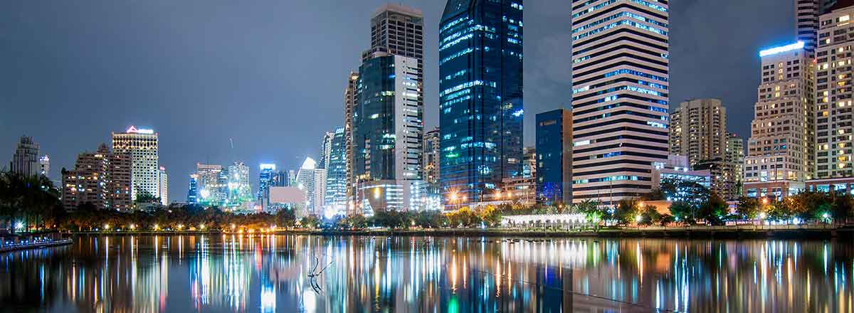 City skyline at night, reflected on water