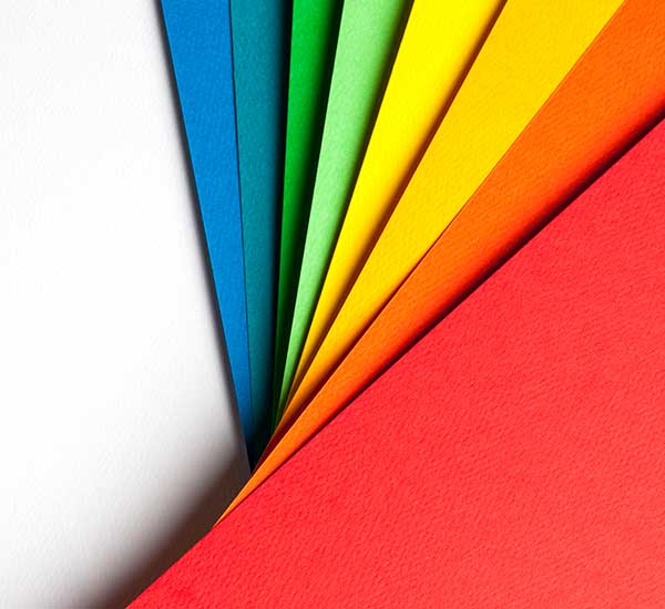 A stack of folders in the colors of the rainbow