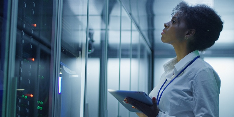 woman looking at a server rack