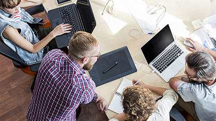 People on computers at a table