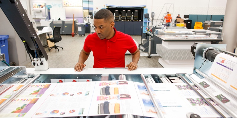 Press operator running a Xerox digital press