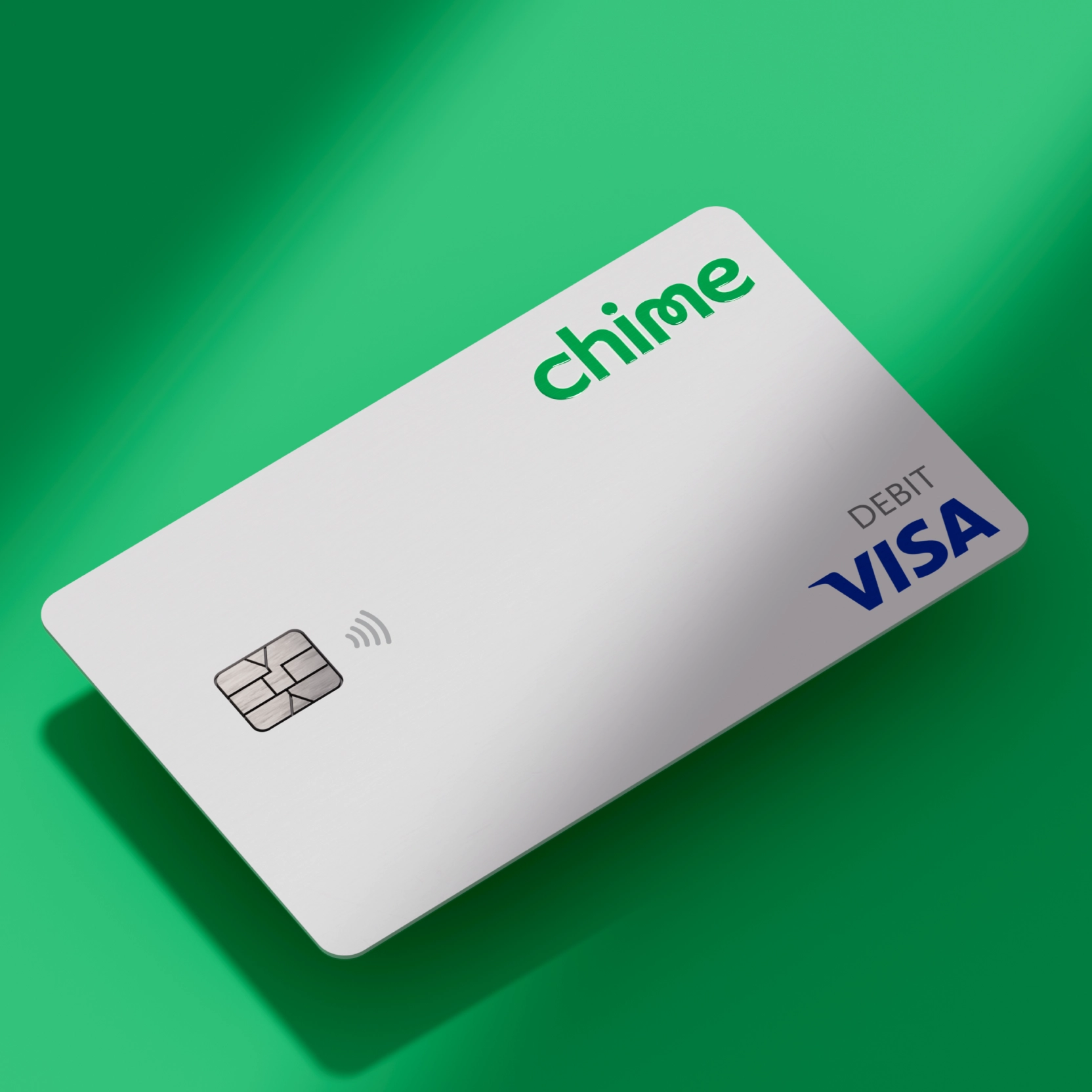 White colored Chime Visa Debit card on green background. 