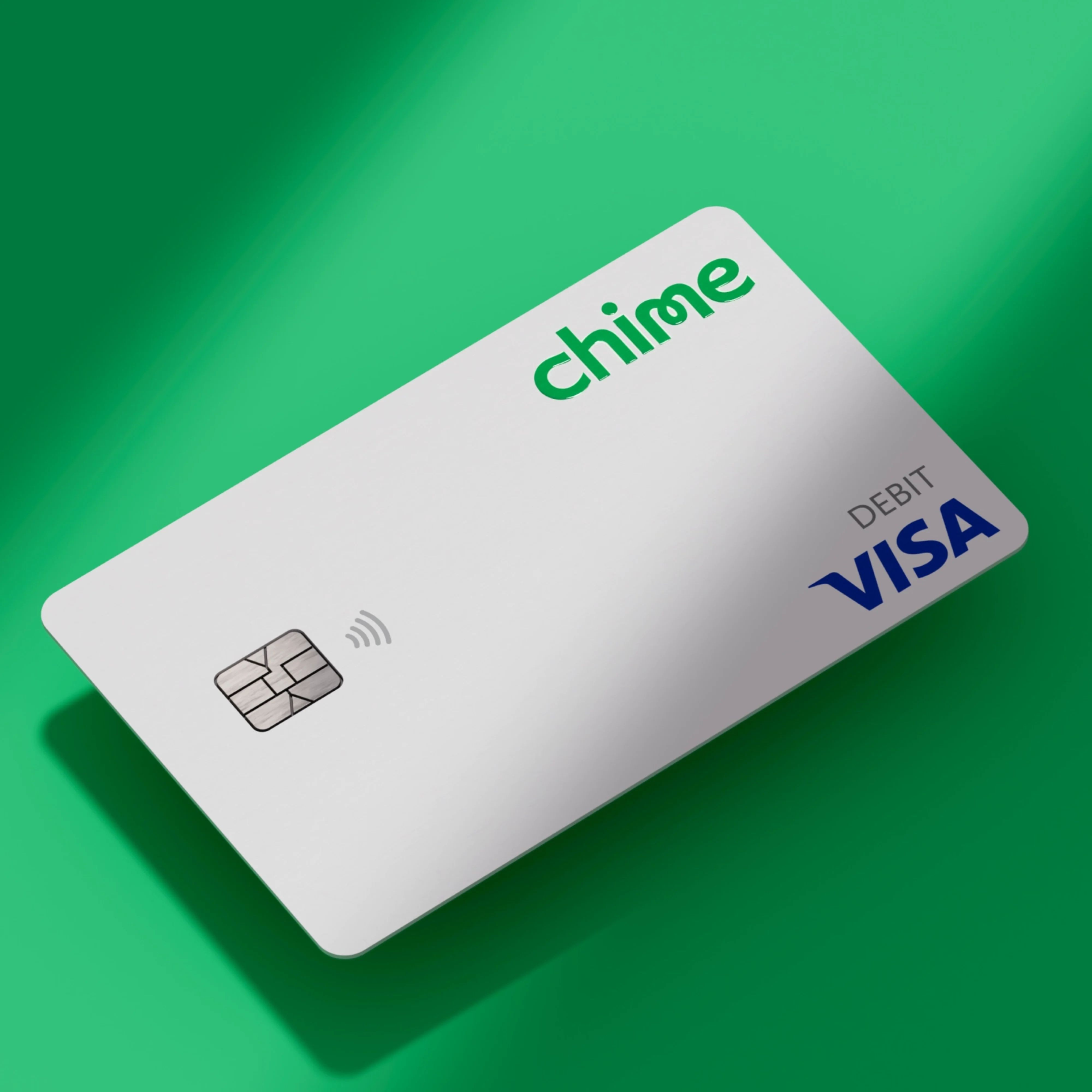 White colored Chime Visa Debit card on green background.