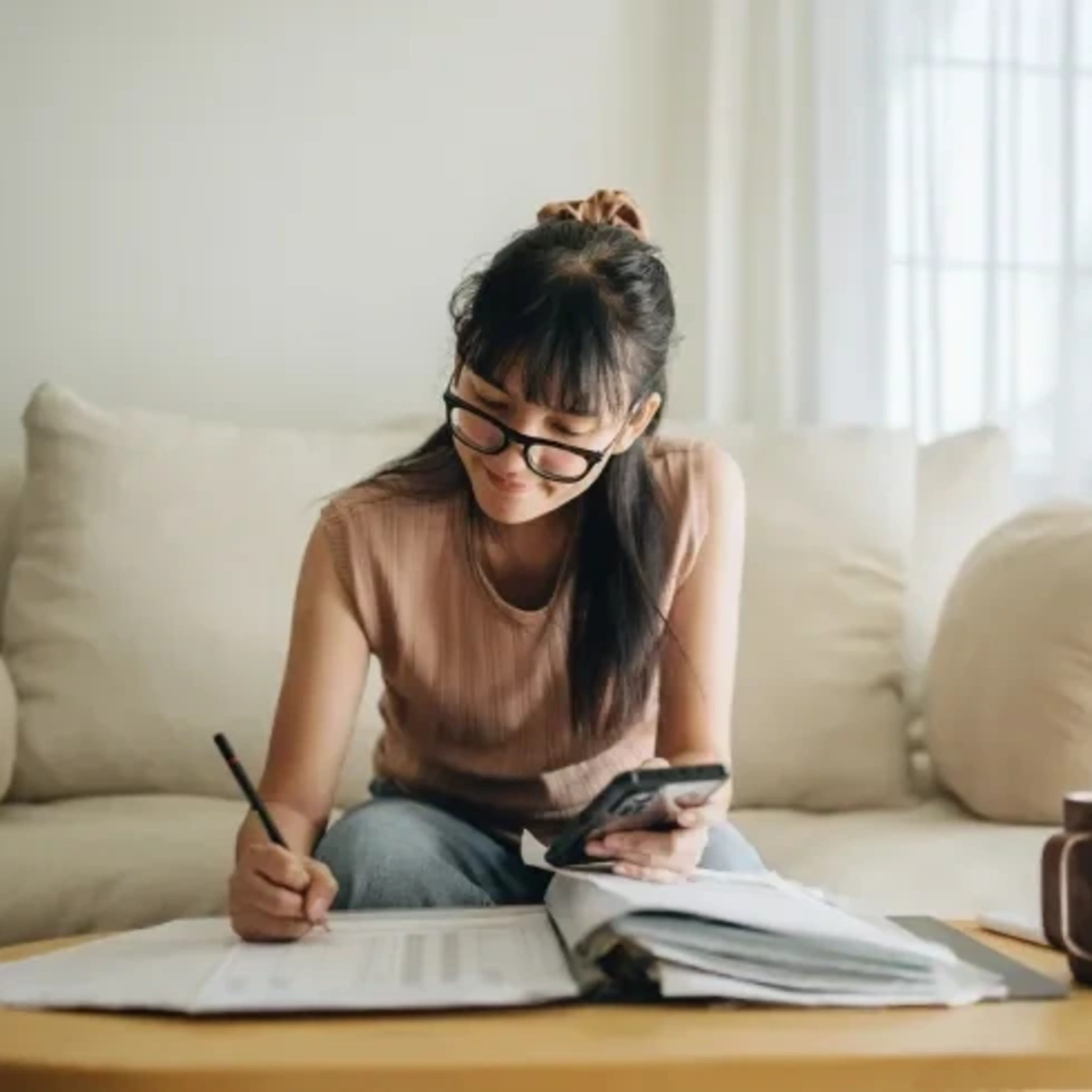 Focused woman managing finances from home.