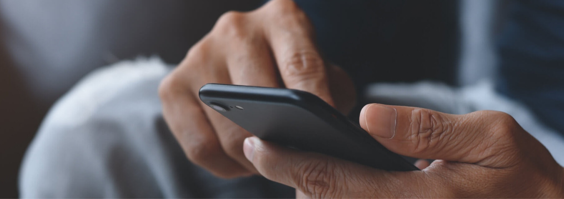 Hands holding a mobile phone