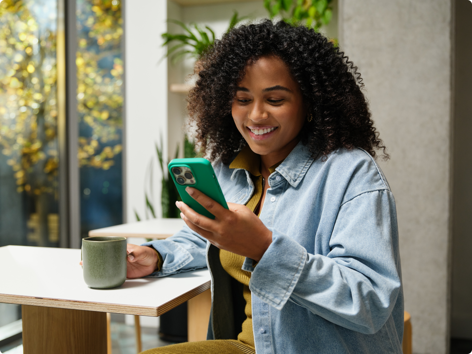 A person looking at their phone and smiling.
