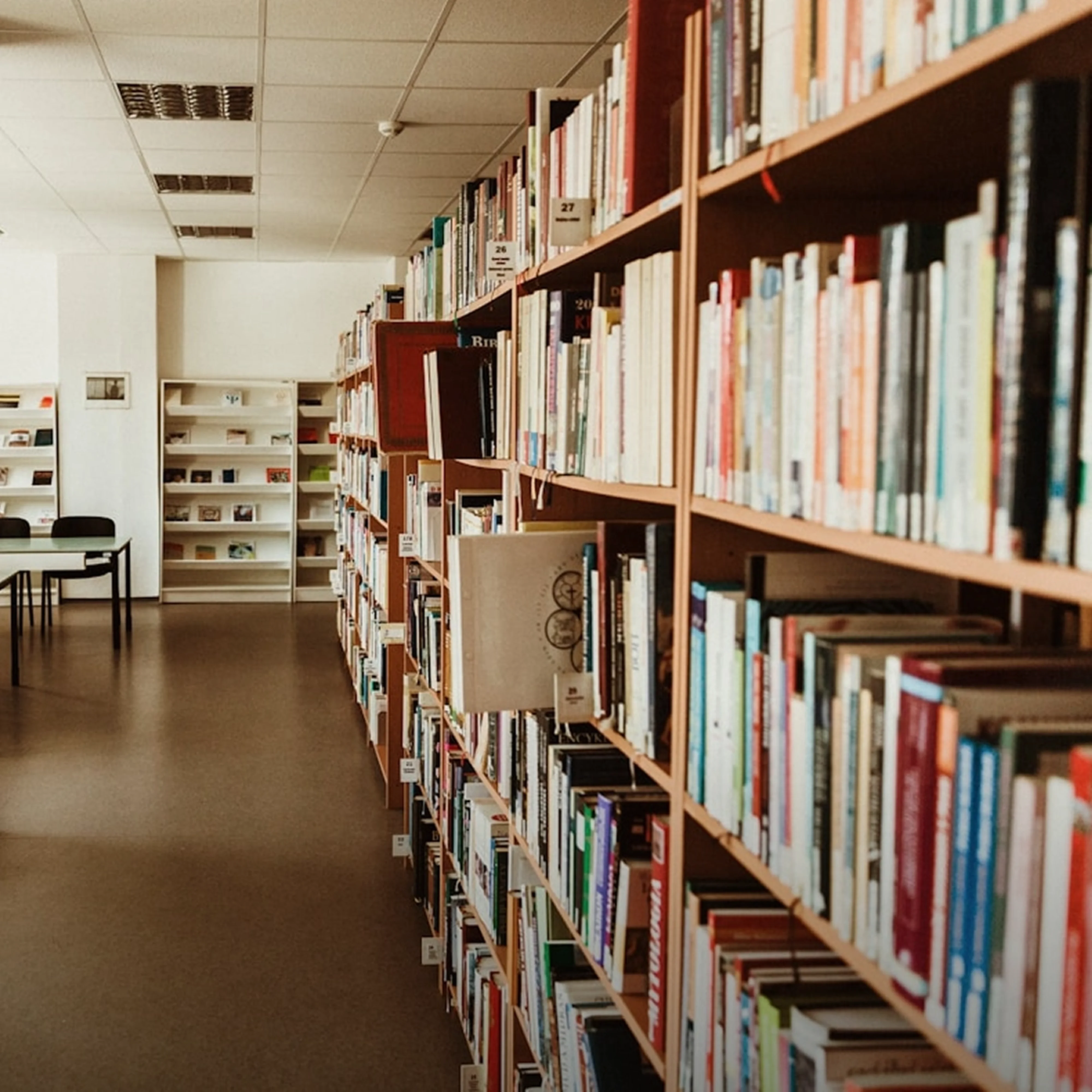 A library with bookshelves filled with books.