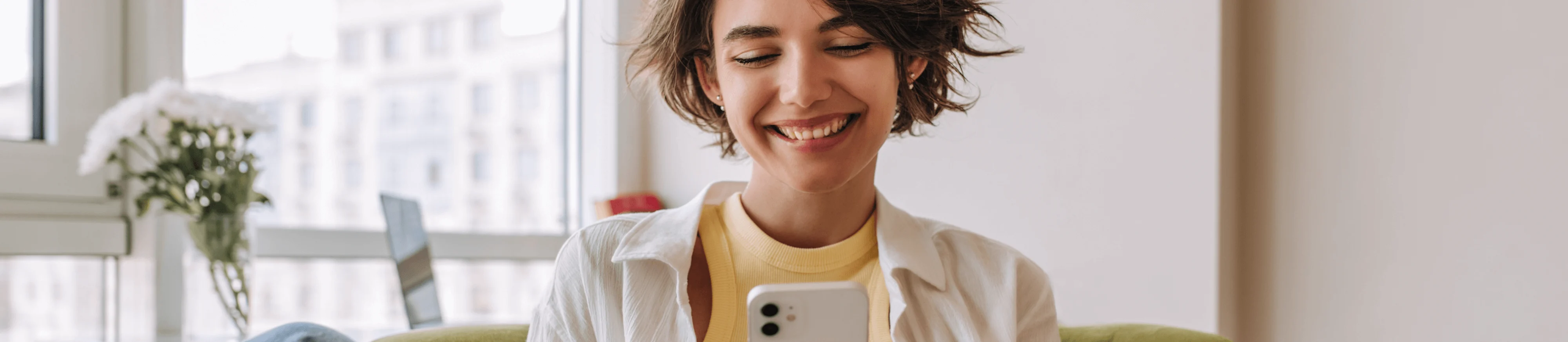 Girl smiling at phone yellow shirt resources what is second chance banking?