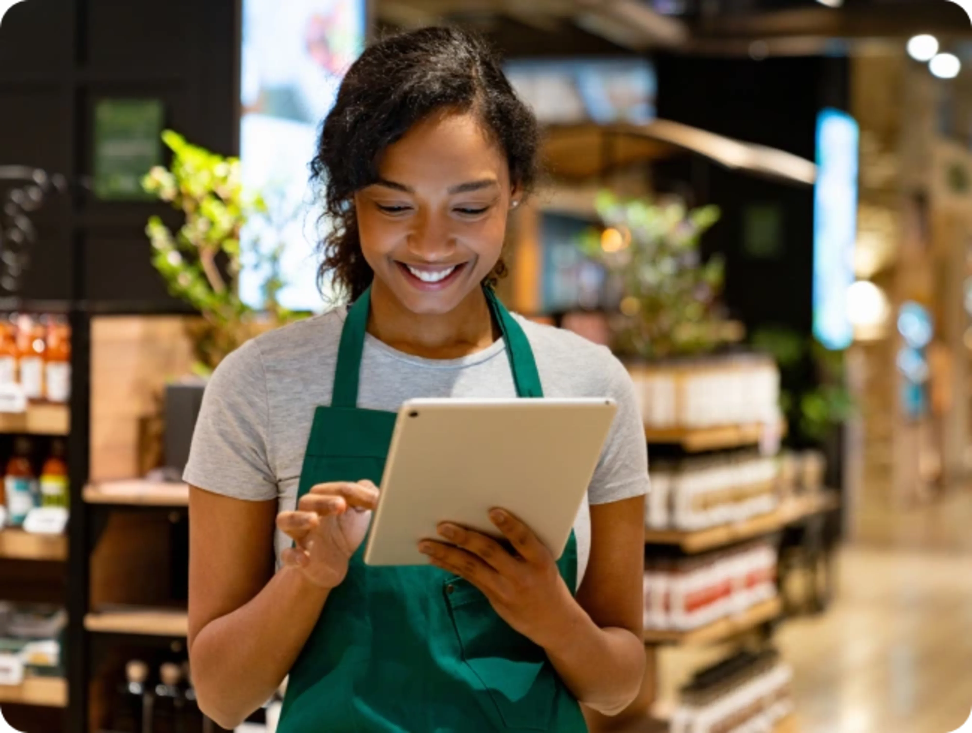 Retail employee reviewing financial wellness data on tablet
