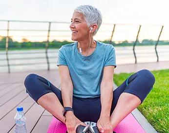 Middle-aged woman exercising with an earphone in her ear