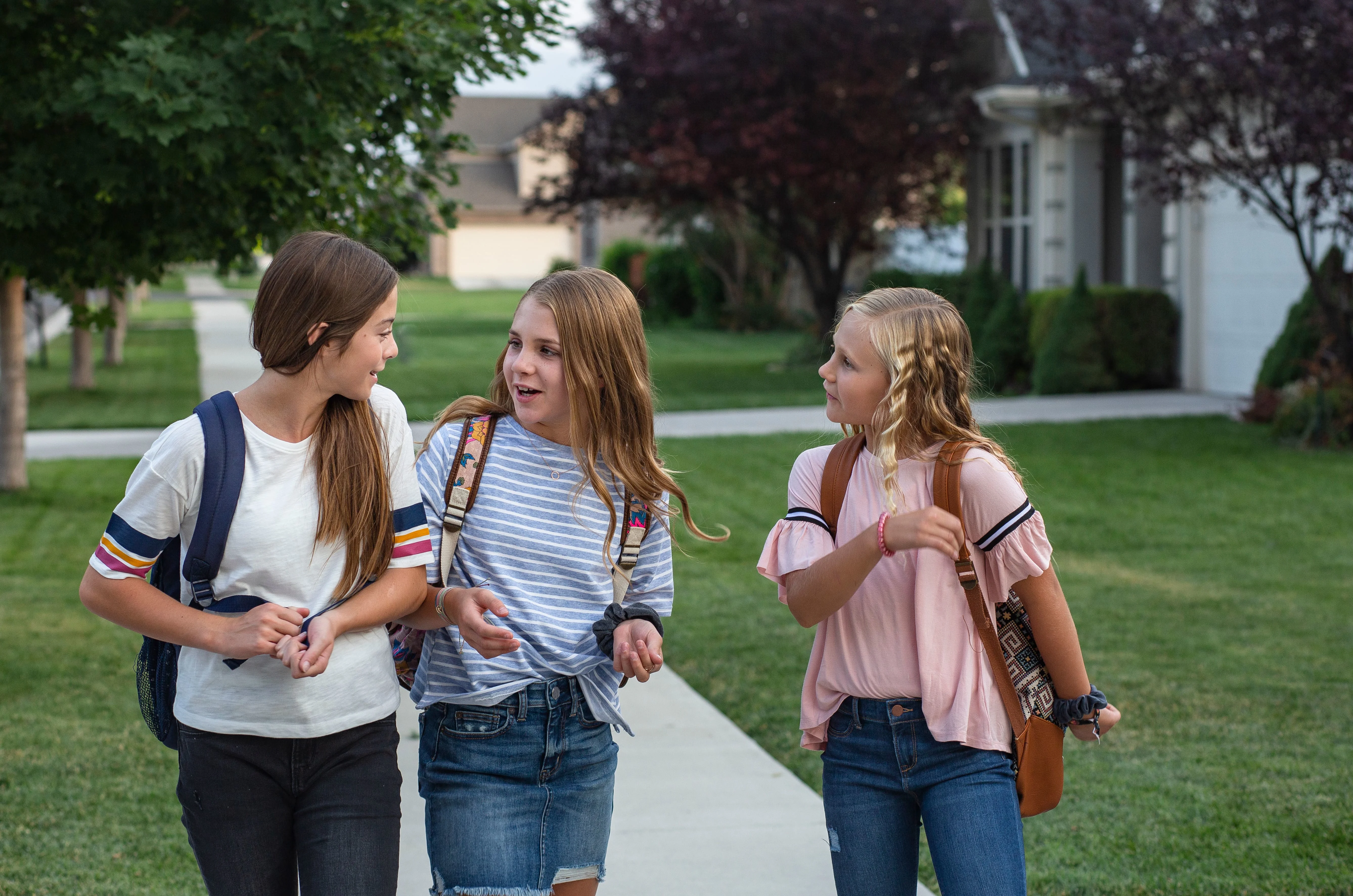 Three girls walking and talking