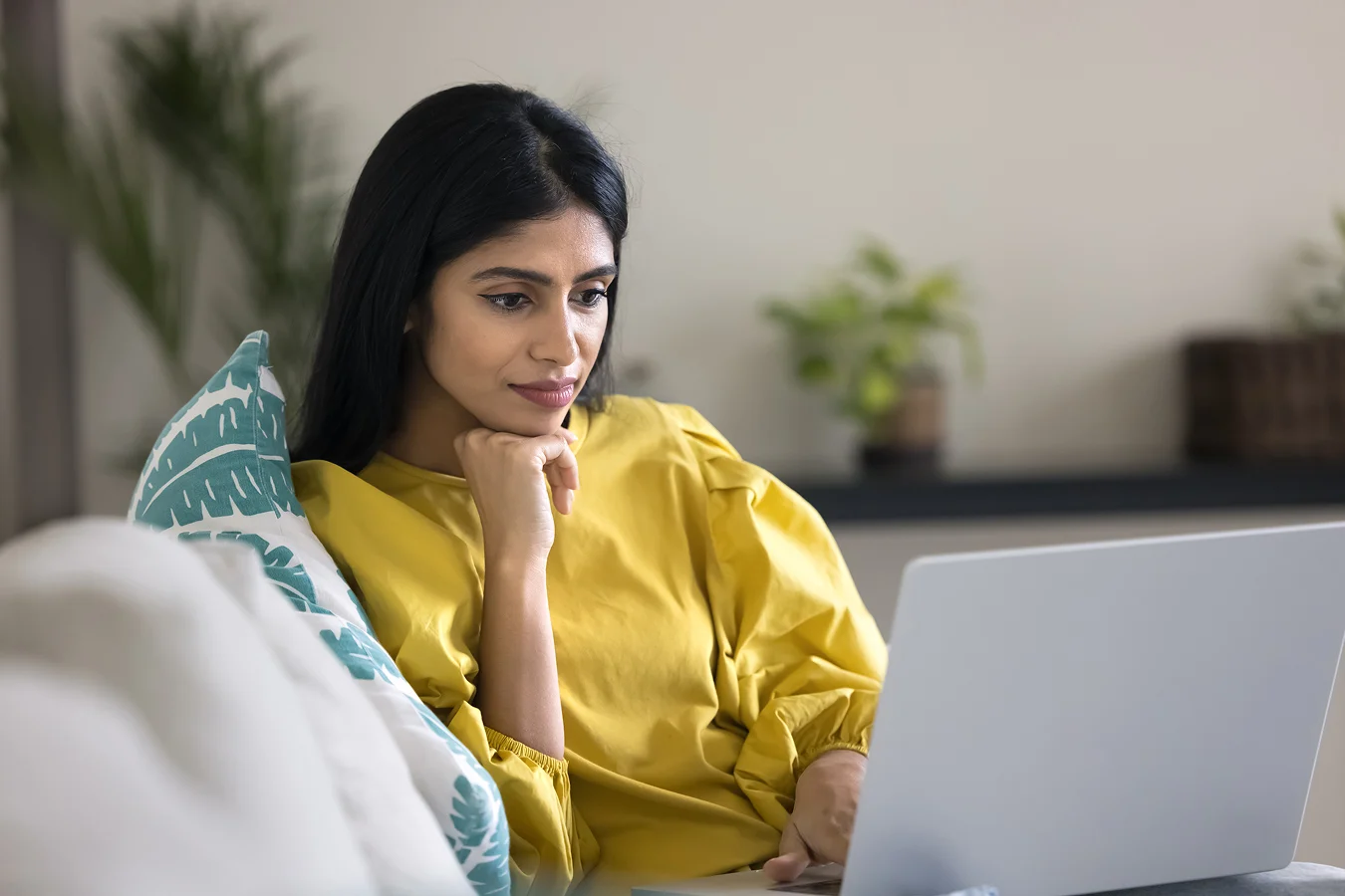 pensive woman looking at computer