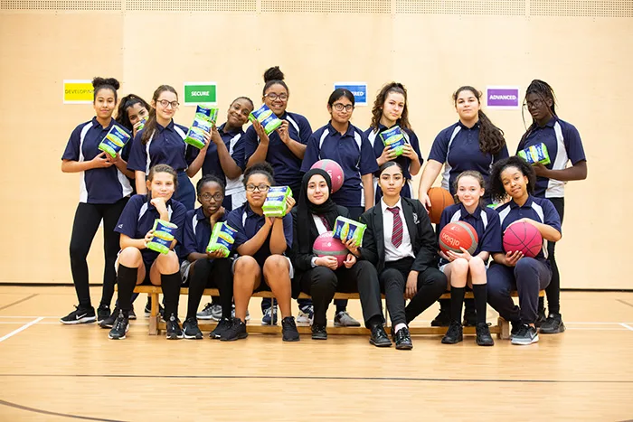Group photo of girls holding Always Sanitary Pads packaging