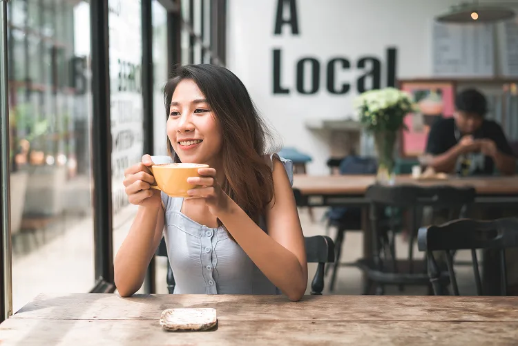 Girl drinking coffee in a coffee shop