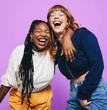 Smiling and hugging young women with the message first period and puberty