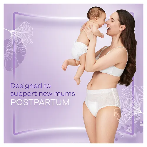 Mum wearing postpartum pants lifting up her newborn baby