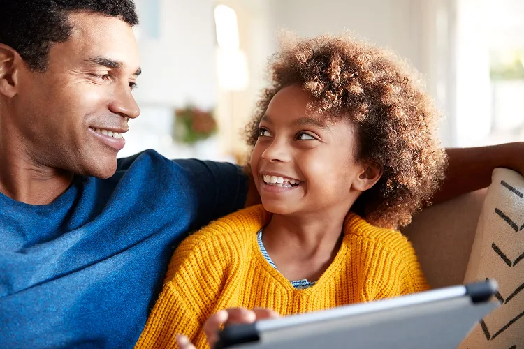 Portrait of a father and daughter looking at each other and smiling