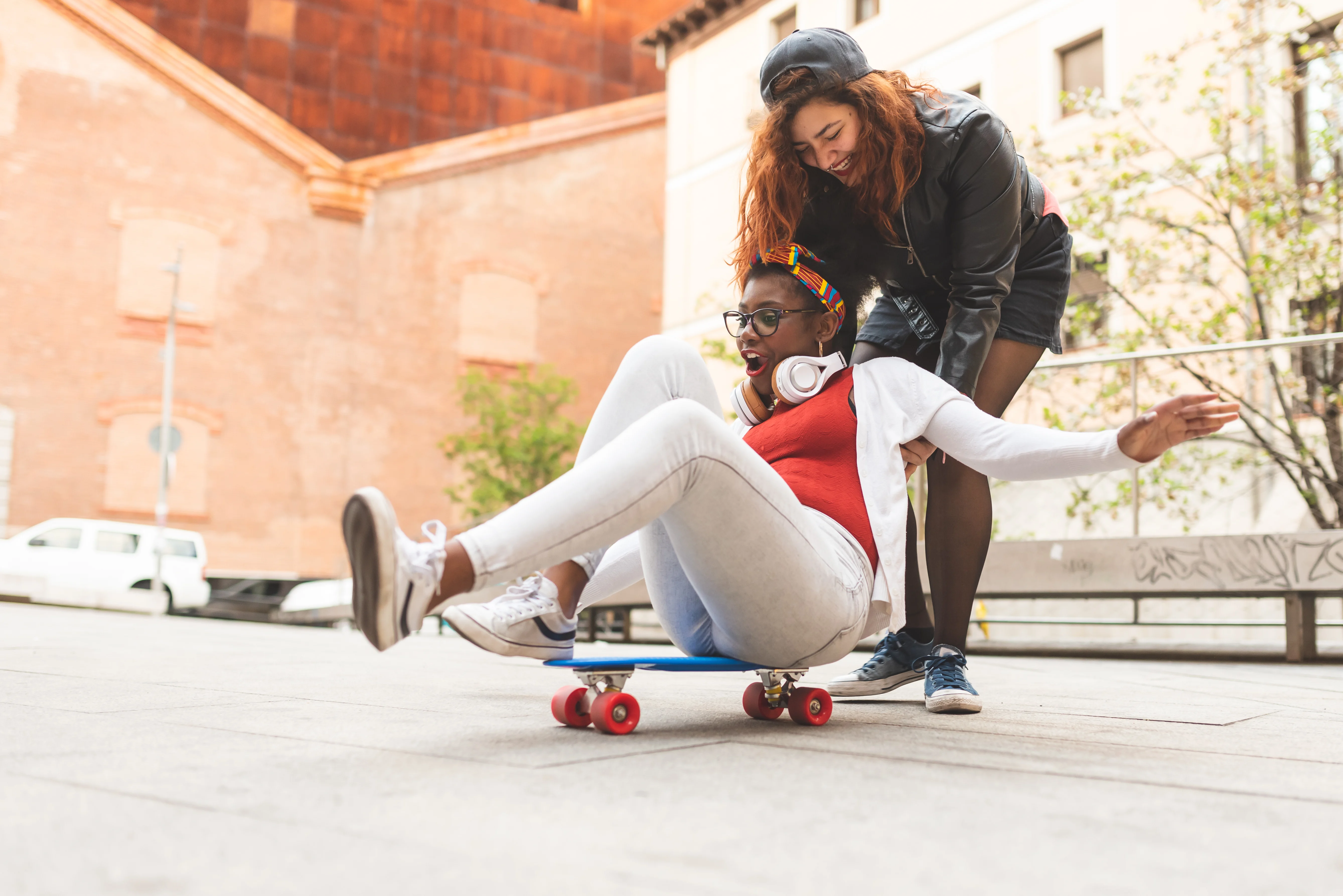 Two girls having fun on a skateboard