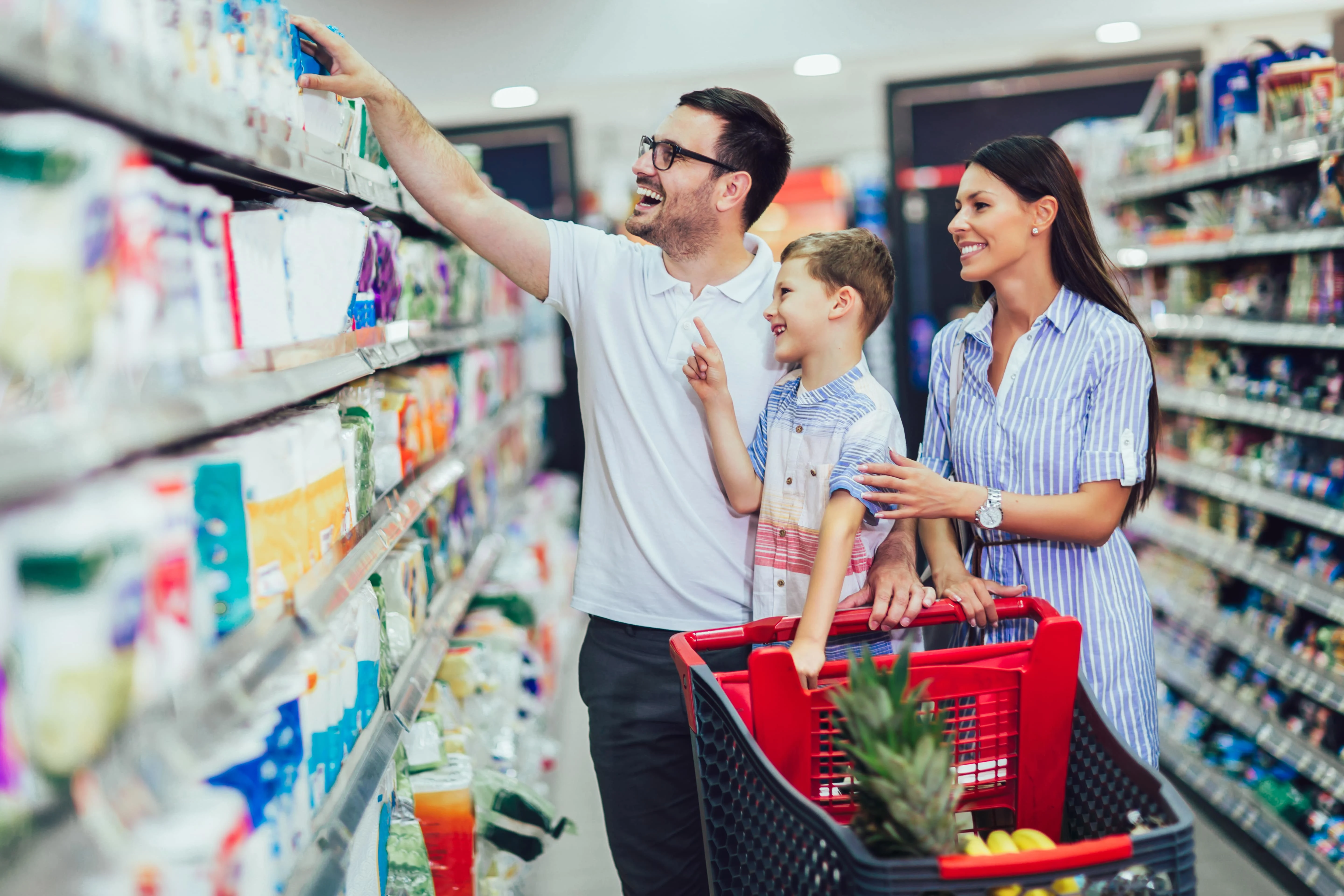 Family in a supermarket looking for period products