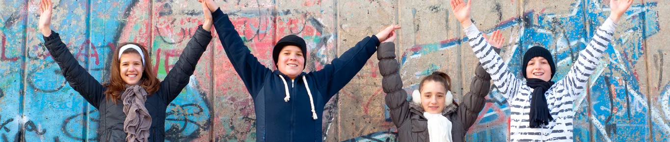 Happy kids with the hands in the air