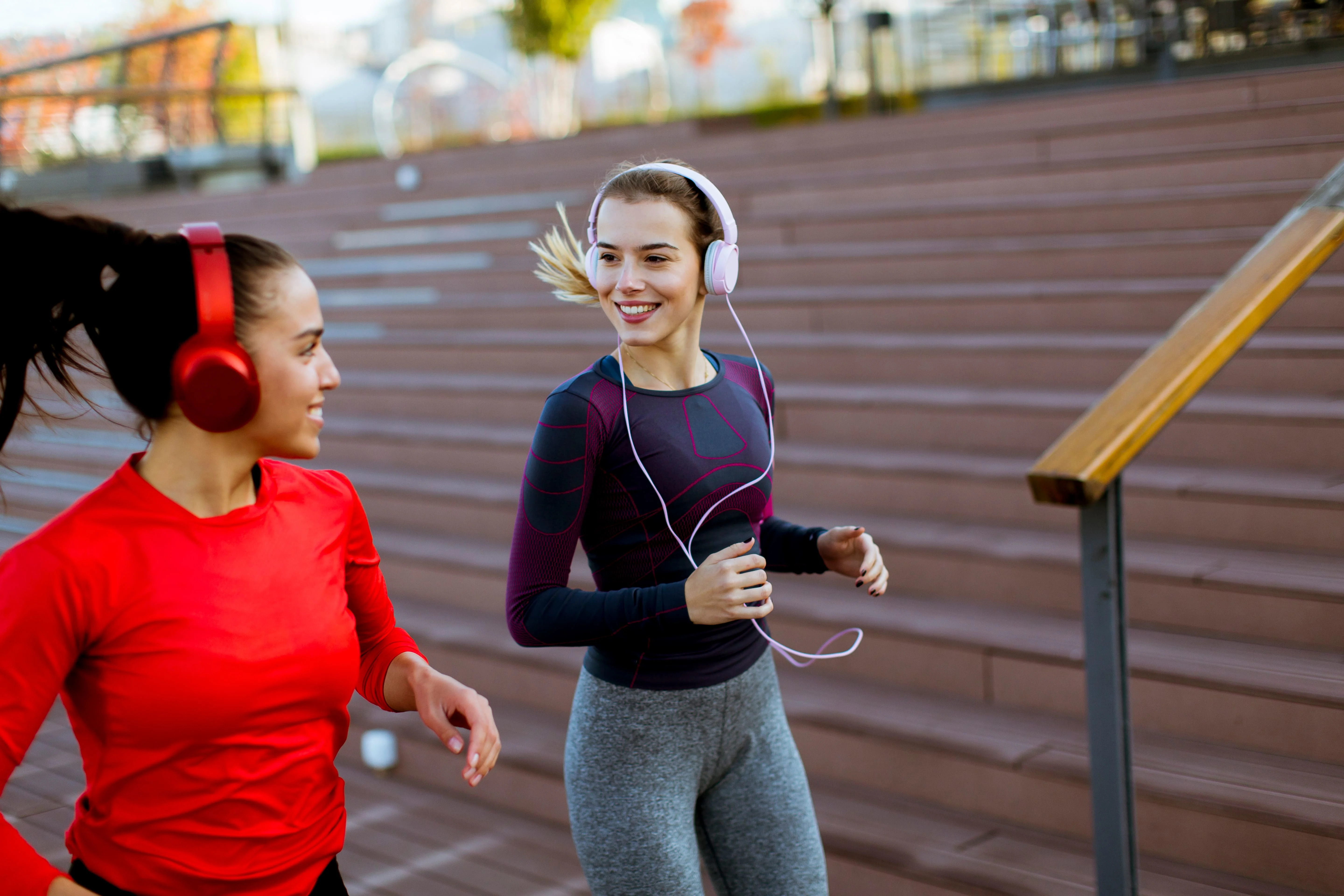 Girls running and listening to music on their headphones