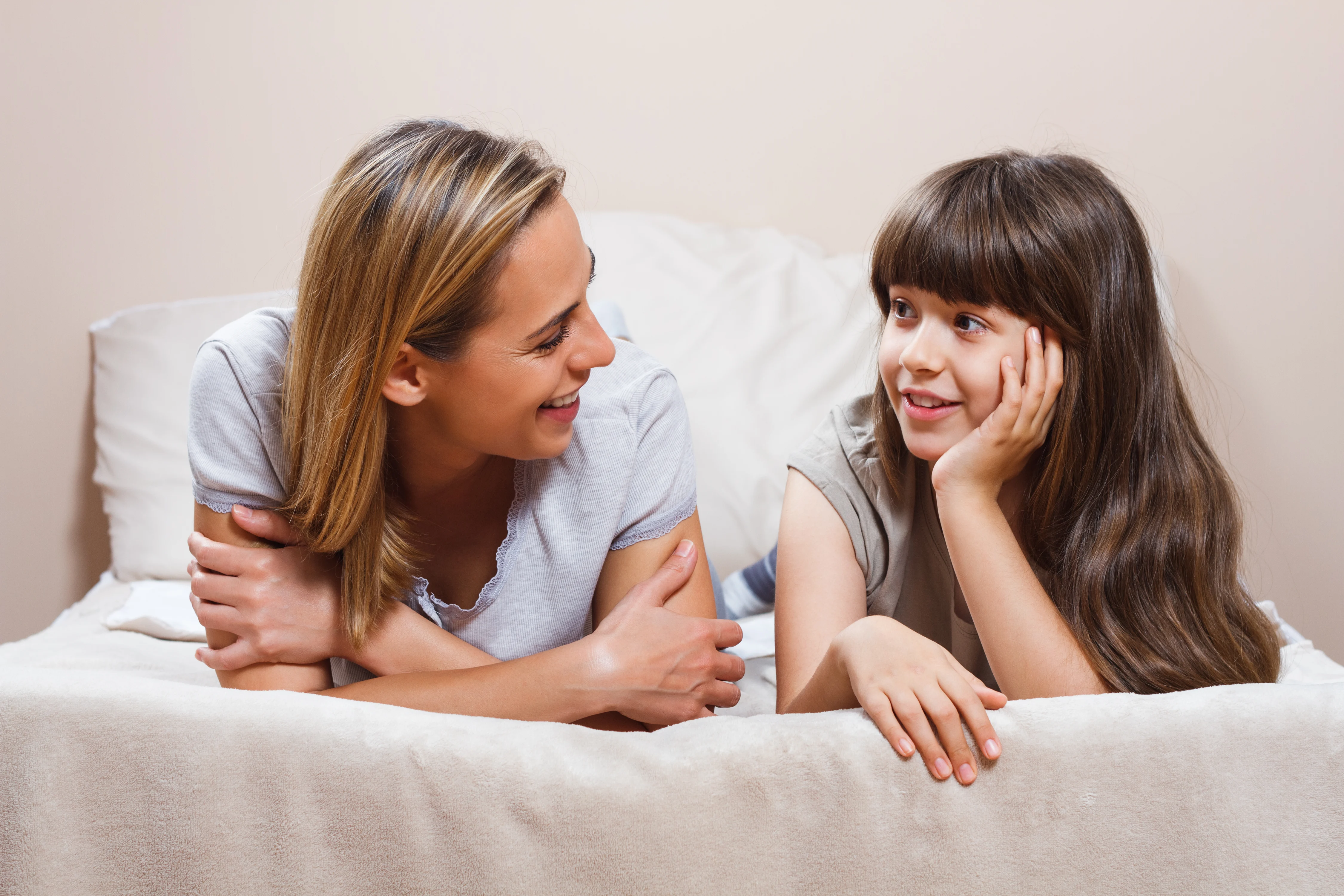 Mum and daughter talking on the bed