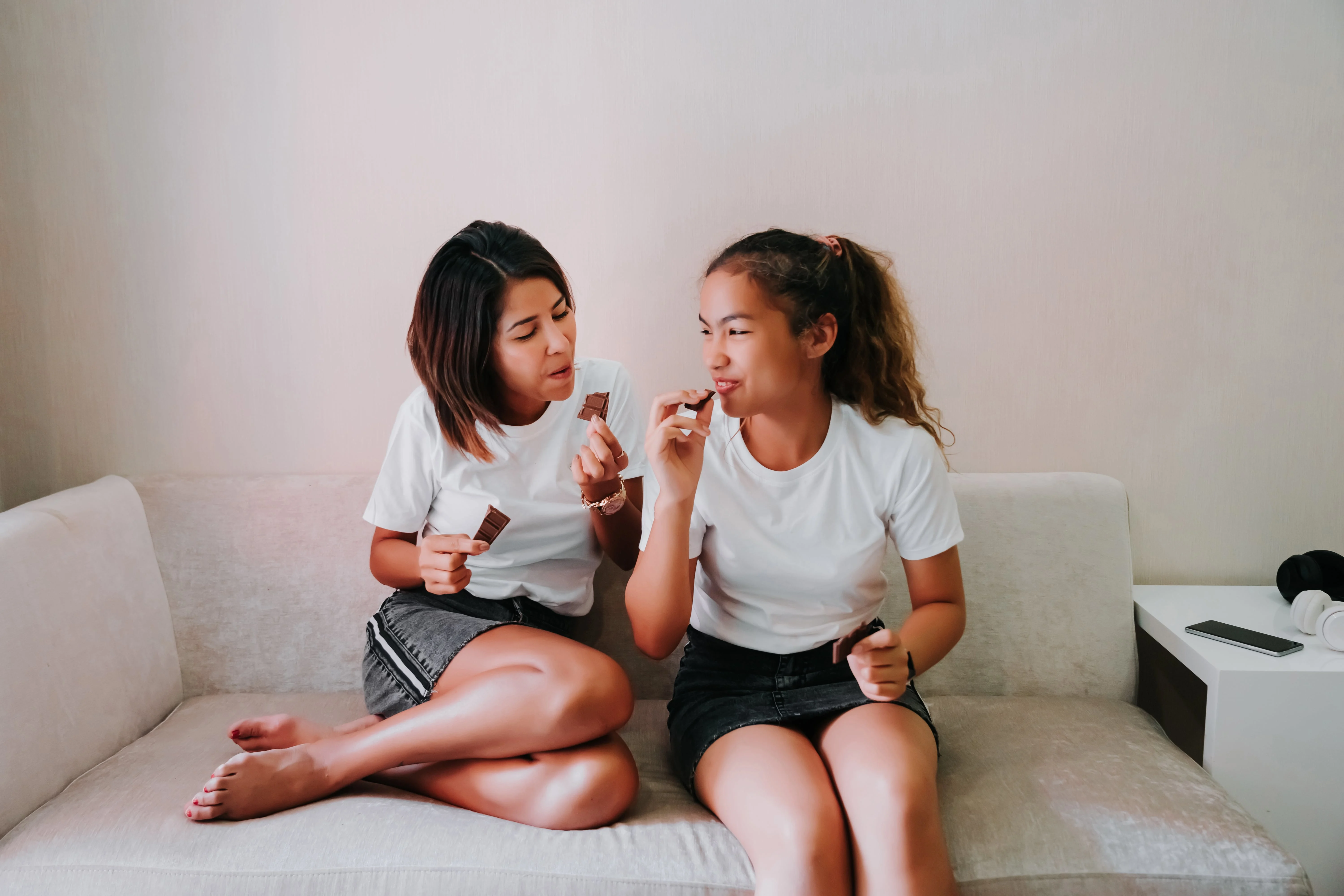 Two girls eating snacks