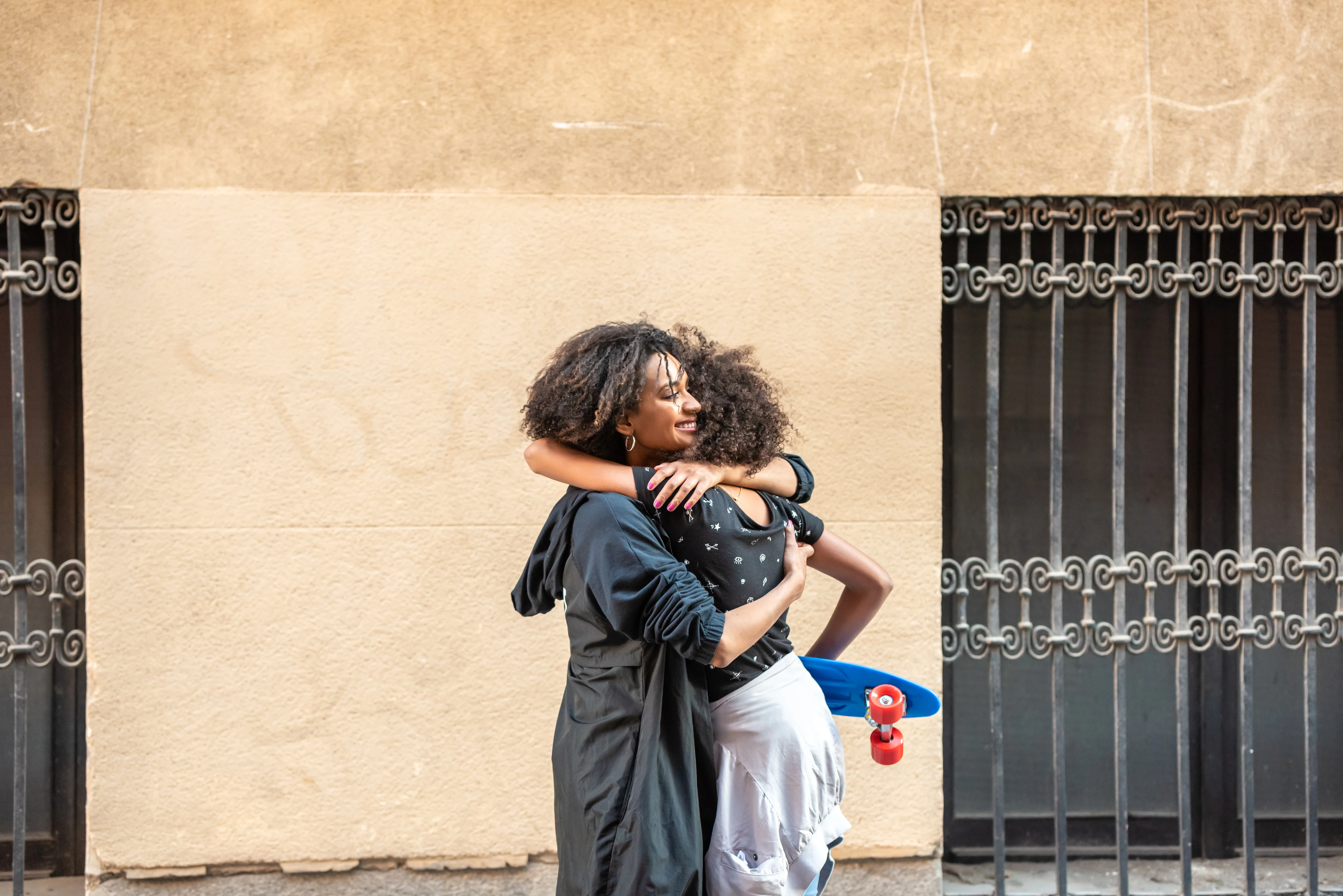 Mother and daughter hugging outdoors