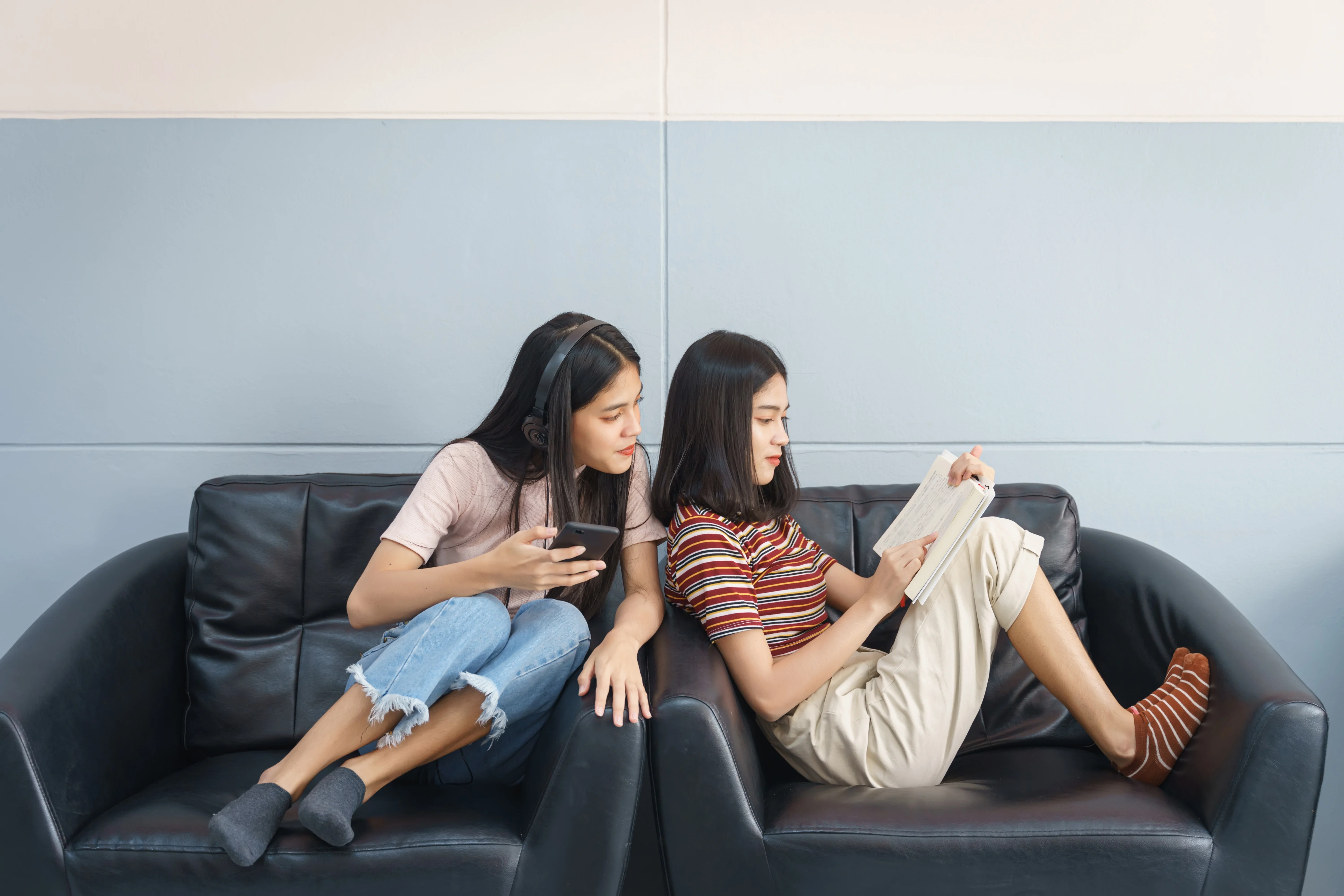 Two girls sitting in chairs and hanging out