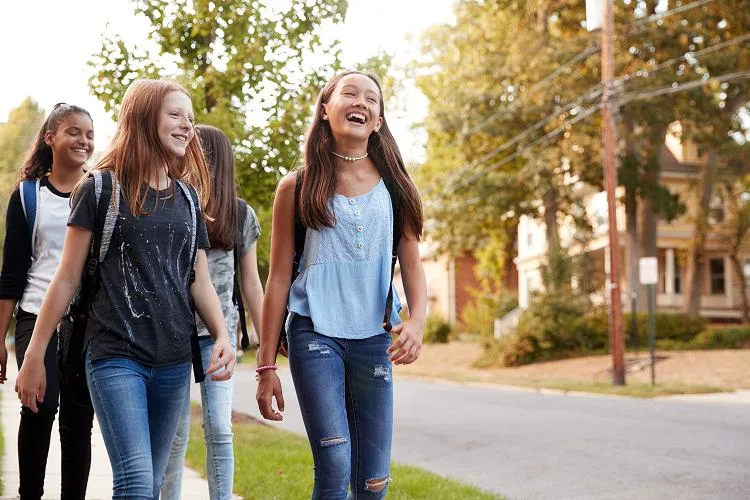 Girls walking down the street and smiling