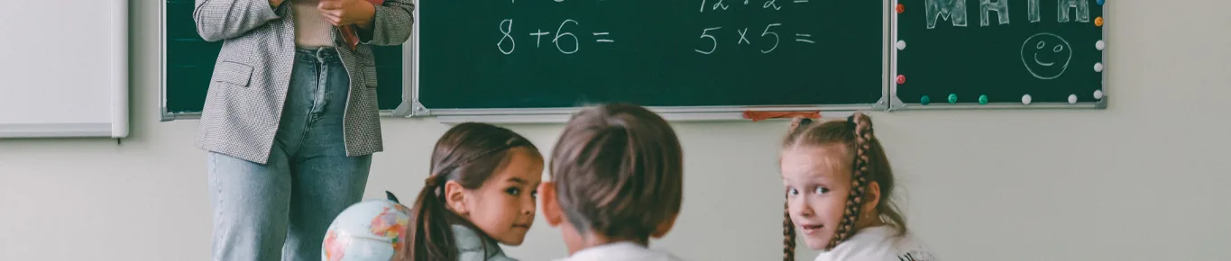 Three children's learning in the class with the teacher