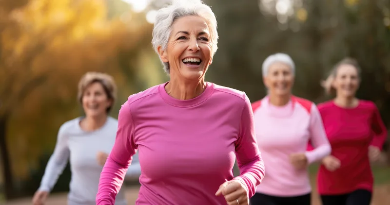 A group of middle aged women laughing and running