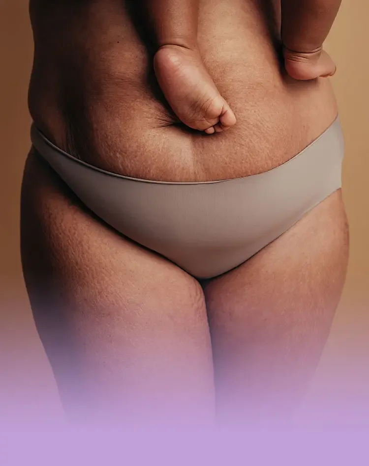 Belly of a woman holding a baby in her arms